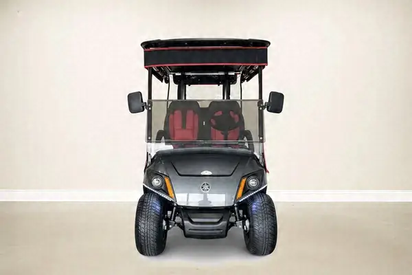 Front of a gray Yamaha golf cart with a black and red roof