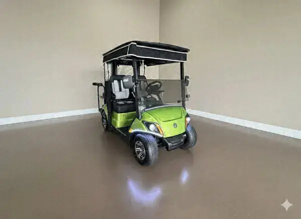 Lime green Yamaha golf cart with a black roof