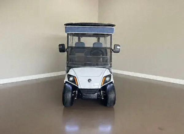 Front of a white Yamaha golf cart with a navy roof