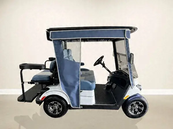 Side view of a white Yamaha golf cart with a navy roof and enclosure