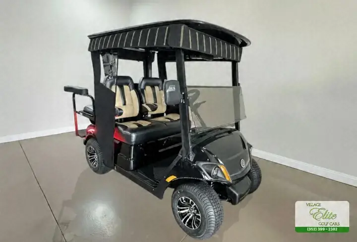 Black Yamaha 4-seater golf cart with tan seats and a black roof