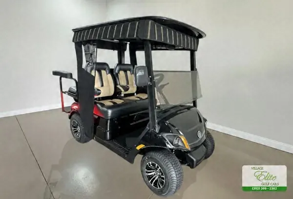 Black Yamaha 4-seater gas golf cart with tan seats