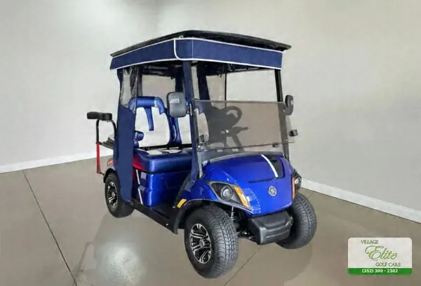 Blue Yamaha golf cart with white seats and a navy roof