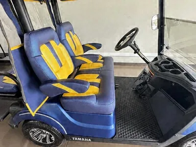 Close-up of the blue and yellow seats on the Yamaha Blue & Yellow golf cart