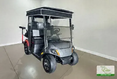 Gray Yamaha golf cart with gray seats and a black roof