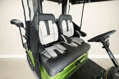 Close-up of the gray and black seats on the lime green Yamaha golf cart
