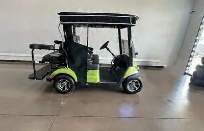 Side view of the lime green Yamaha golf cart with a rear flip seat
