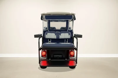 Rear of the white Yamaha golf cart with blue rear seats and red taillights
